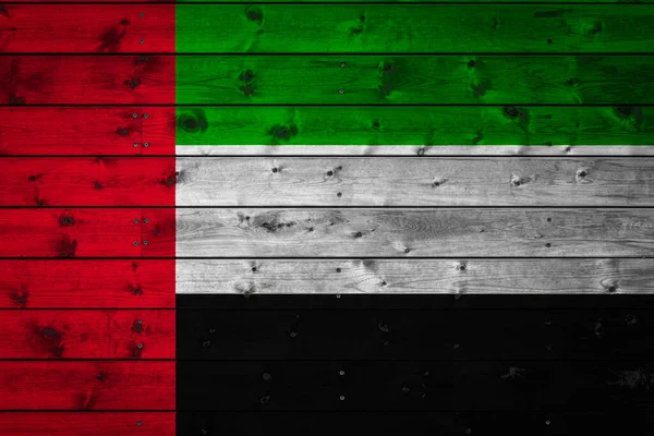 The national flag of United Arab Emirates is painted on a camp of even boards nailed with a nail. The symbol of the country.