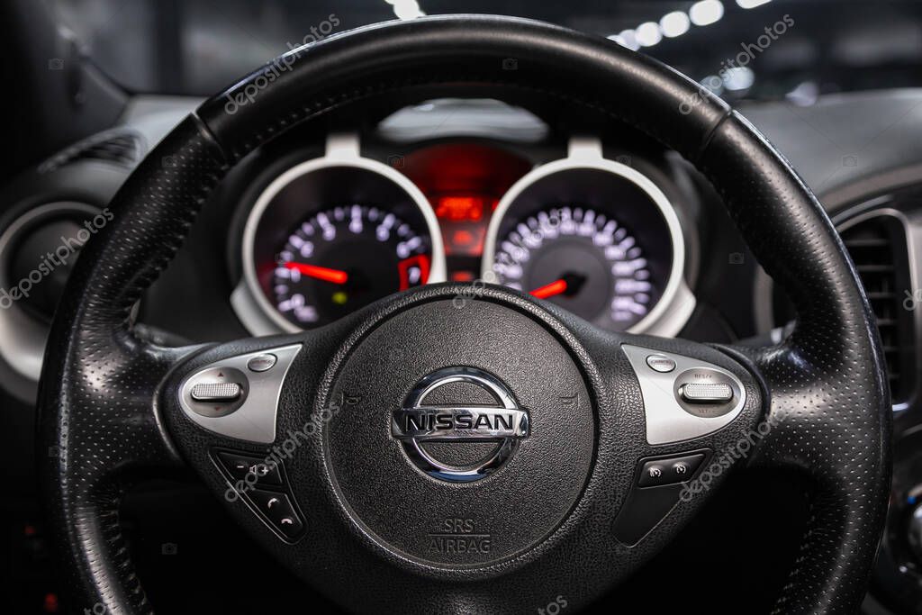 Novosibirsk/ Russia  June 10  2020:  Nissan Juke, Black luxury car Interior - dashboard, player, steering wheel with logo and buttons, speedometer and tachometer