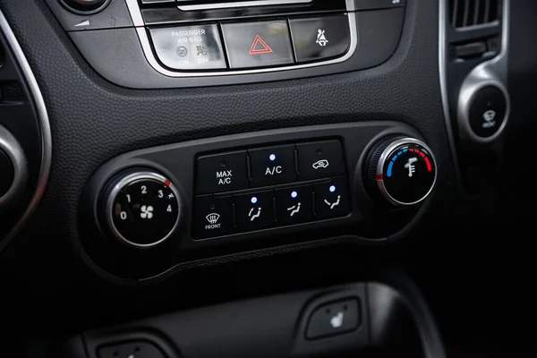 close up of  car panel with the air conditioning button inside a car