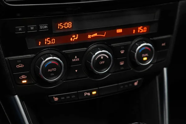 close up of  car panel with the air conditioning button inside a car