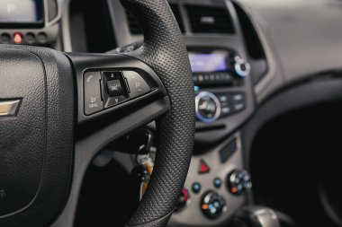 Novosibirsk/ Russia  August 25  2020: Chevrolet Aveo, New black steering wheel with multifunction buttons for quick control phone, music and other function clipart