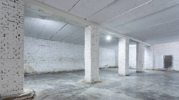 Industrial building interior with white brick walls, concrete floor and empty space for product display or industrial background