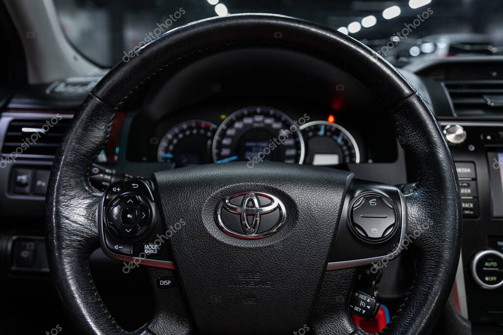 Novosibirsk/ Russia  August 01  2020: Toyota Camry,  dashboard, player, steering wheel with logo and buttons, speedometer and tachometer