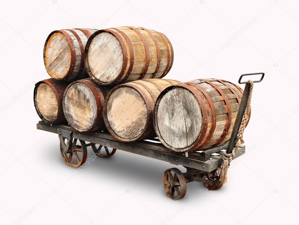Old wooden wine barrels piled on a cart isolated in white background.