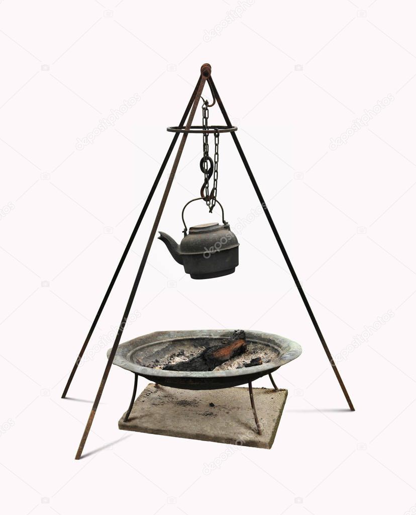 Dutch oven cast iron kettle and rod tripod over firewood metal pan.