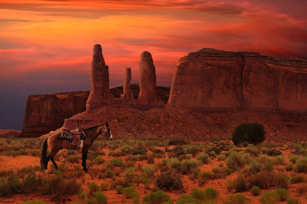 Three Sisters and a horse in Monument Valley Tribal Park, Arizona USA
