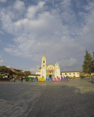Chignahuapan, Puebla Mexico. June 23 2019: Panoramic view of the indigenous Baroque church Parroquia de Santiago Apóstol in the central Plaza de Armas clipart