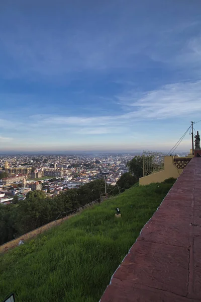 Panoramic view of the city, Popocatepetl volcano, San Gabriel Convent, the city is famous for its Great Pyramid, the largest archaeological site in the world at its base — Stock Photo, Image