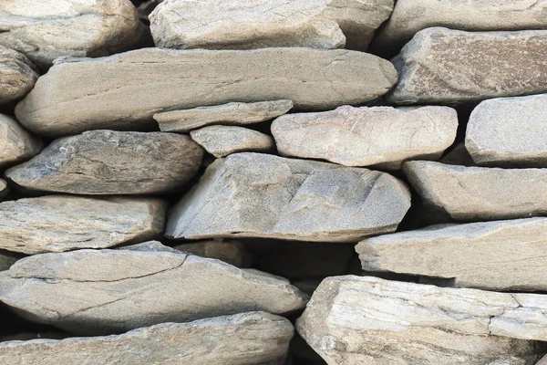 stone fence of solid pieces of stone