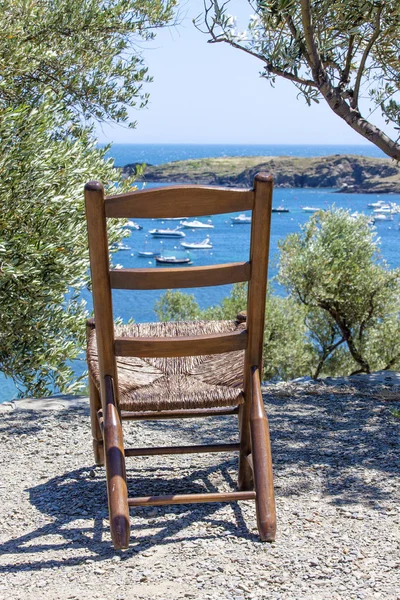 lounge chair on the beach with the yacht