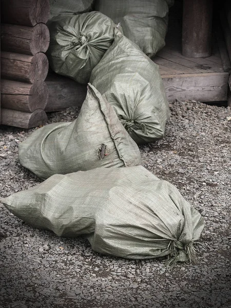 The bags of trash at the entrance in a wooden house