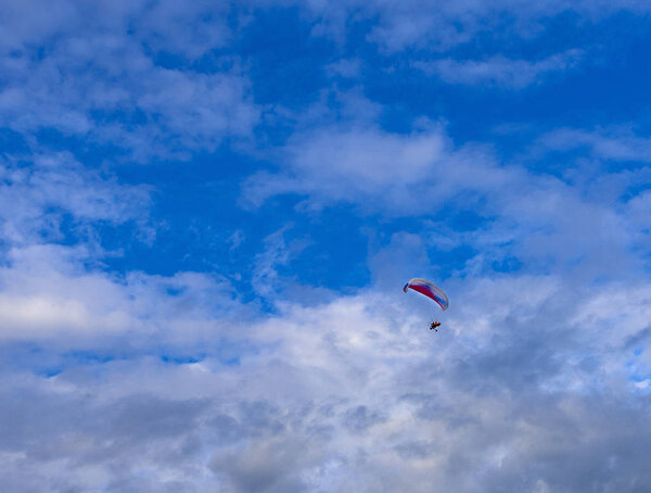 The Paragliders with engine with blue sky background 