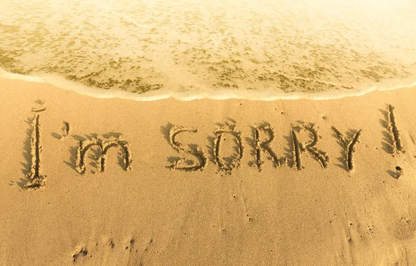 Inscription on the heat yellow sand  I m sorry — Stock Photo, Image