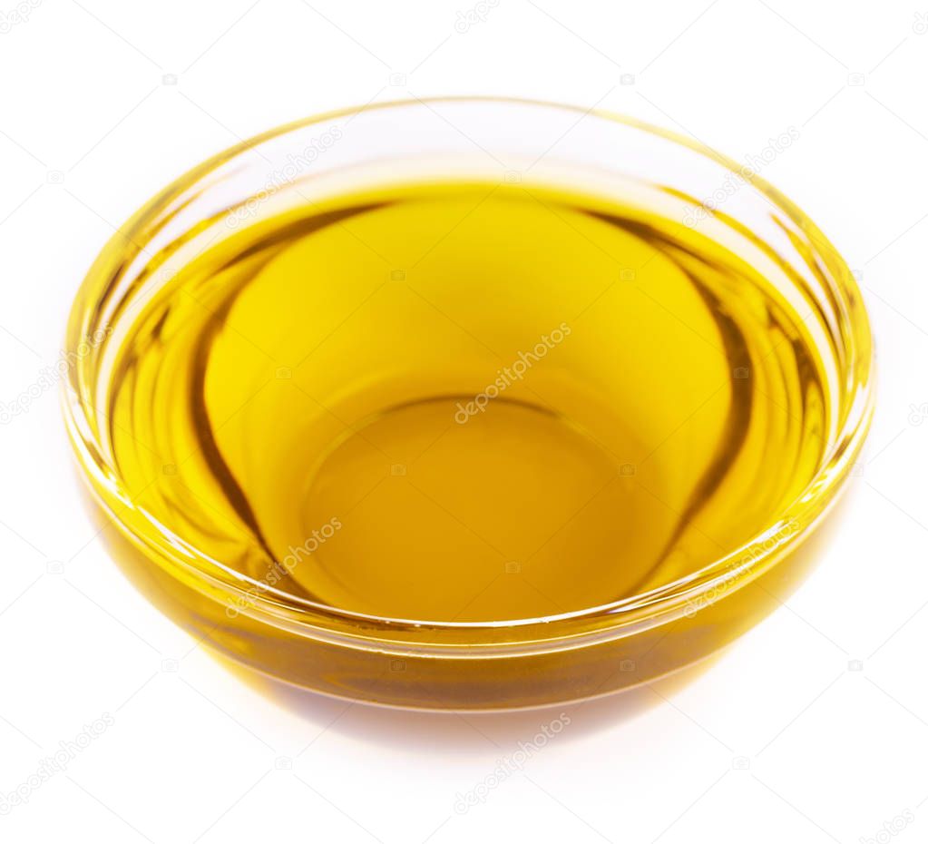 The Pouring cooking oil a small glass cup  isolated on white bac