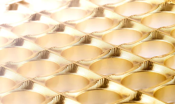 The shiny gold plastic background as texture of the empy candy b