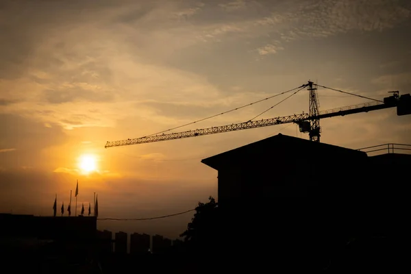 silhouette crane construction site on sunset time background.