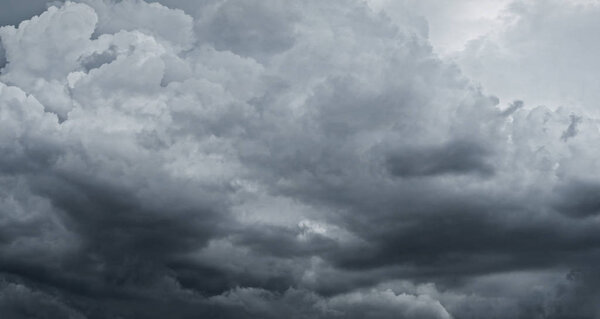 Dark storm clouds before rain used for climate background. Clouds become dark gray before raining. Abstract dramatic background.