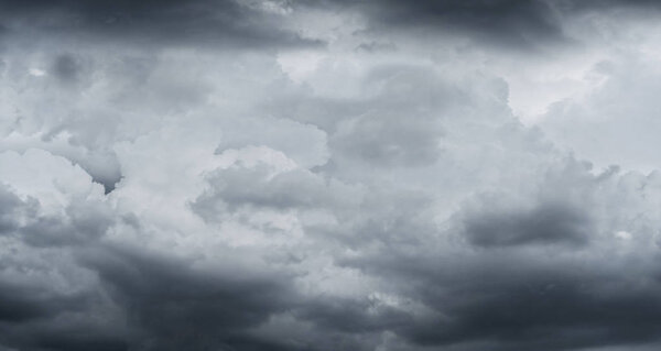 Dark storm clouds before rain used for climate background. Clouds become dark gray before raining. Abstract dramatic background.