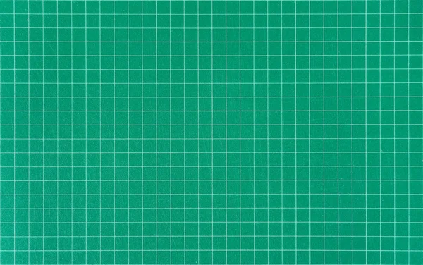 Green cutting mat with printed grid line.