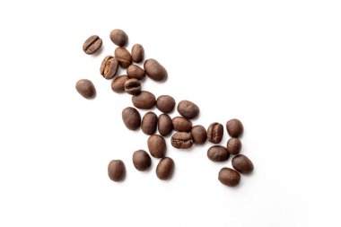 Beyaz zemin üzerine kavrulmuş kahve çekirdekleri. Yakın çekim yansıma.