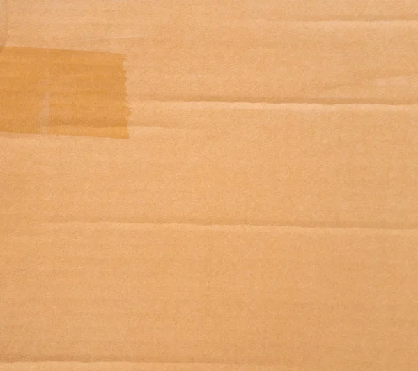Brown paper box or corrugated cardboard sheet texture for background.