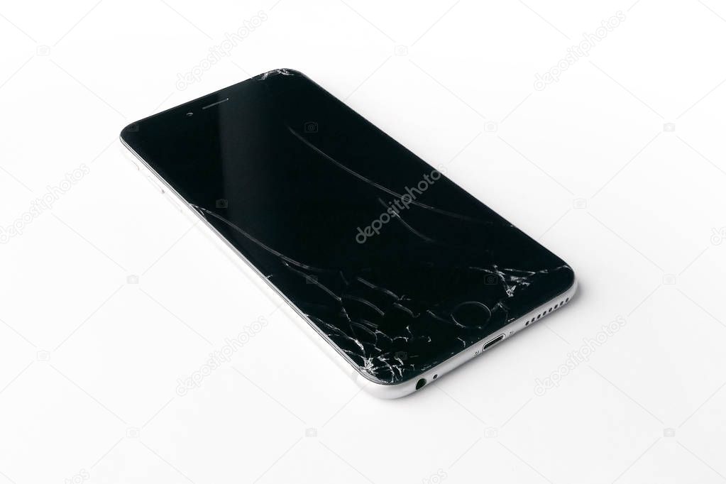 Mobile smartphone with broken screen isolated on white background.
