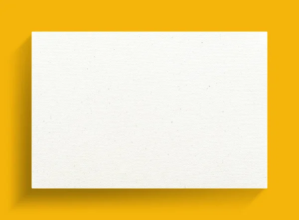 Quadro de lona branca em um fundo amarelo . — Fotografia de Stock