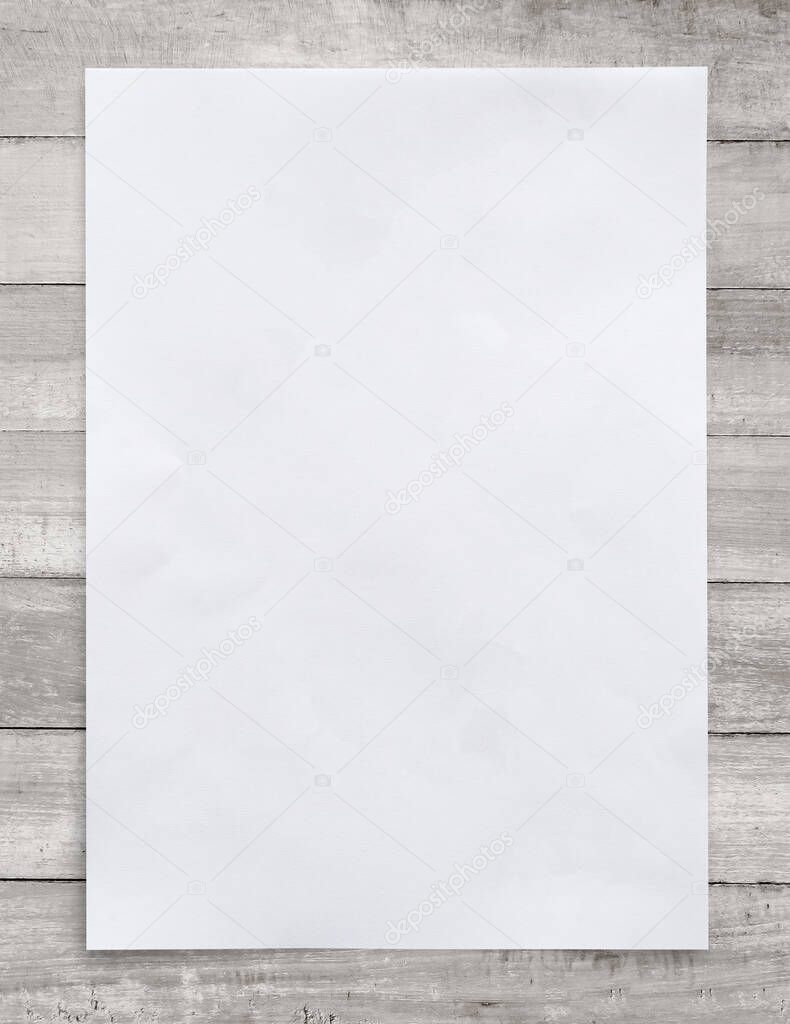 White paper sheet on wood for business background. Close up image.