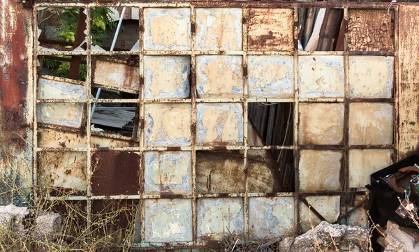 Old squared broken metal glass painted window.