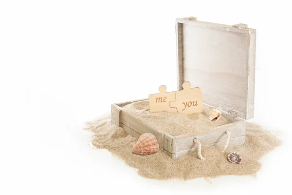 Opened Wooden Chest Two Puzzle Pieces Seashells Sand White Background — Stock Photo, Image