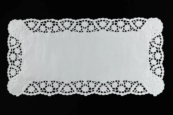 White paper lace doily, closeup on black background. — Stock Photo, Image