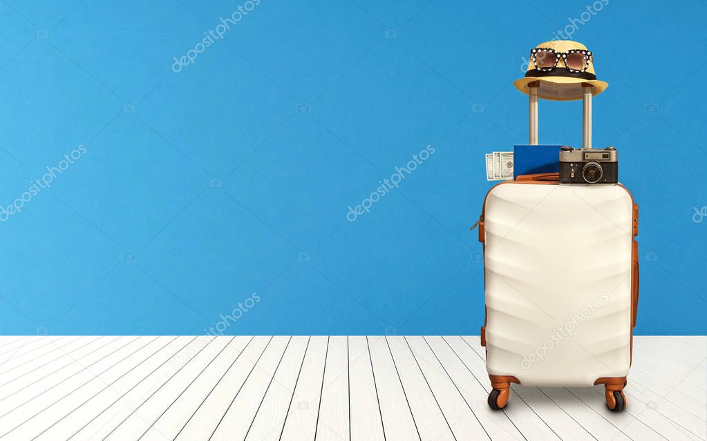 Time to Relax, traveling suitcase with hat standing on the floor out the room.Travel concept.