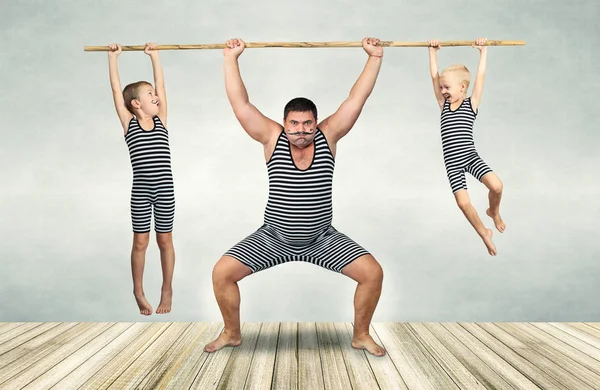 Güçlü adam ailesi. Vintage kostüm sporcuların iki oğlu babası güç egzersizleri yapın. Aile bak.