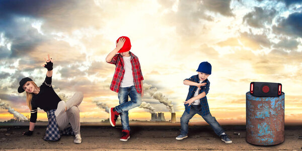 Mother and two son dance hip-hop.Urban lifestyle. Hip-hop generation.