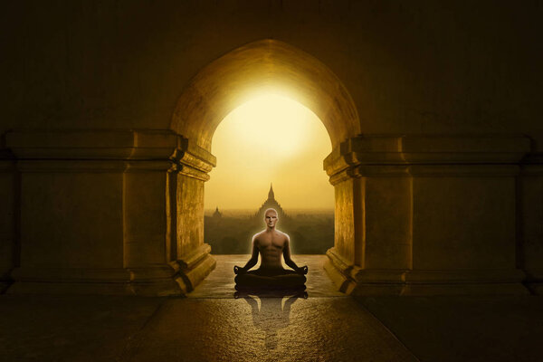 Man in yoga pose meditating in a Buddhist temple