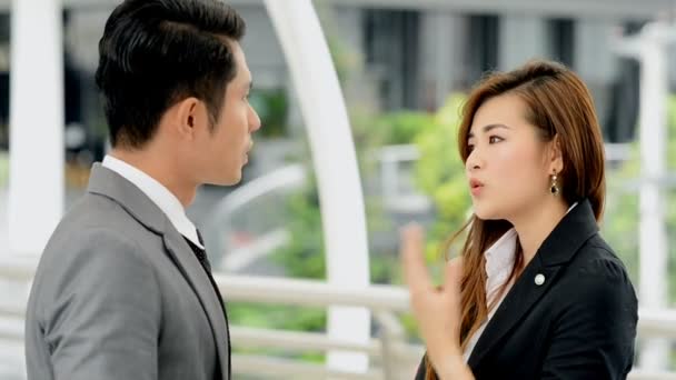Young generation business team not working together concept. Young business intern Asian woman having very serious fight and arguments with her Asian male manager, with dramatic expression.
