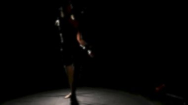 Sportswoman karanlık arka planda boks