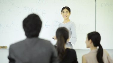 Asya Üniversitesi yaşam kavramı. Genç Asyalı üniversite öğrencilerinin öğrenme, konuşmak ve dinlemek için öğretim görevlisi konferans odasında oturma grubu.
