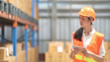 Kalite Denetçisi'nde küçük depo. Genç Çinli kadın Müfettiş küçük depo emniyet gerçek ambarındaki teftiş.