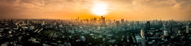 Aerial view of sunset over large metropol city in Asia. With tall building and skyscraper in background. Panoramic shot. clipart