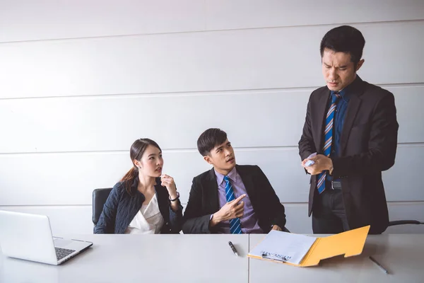 Businessman ripping off contract document. Young asian male in suit with beautiful young asia woman sitting together and saw man ripping off their contract document. Employment termination concept.