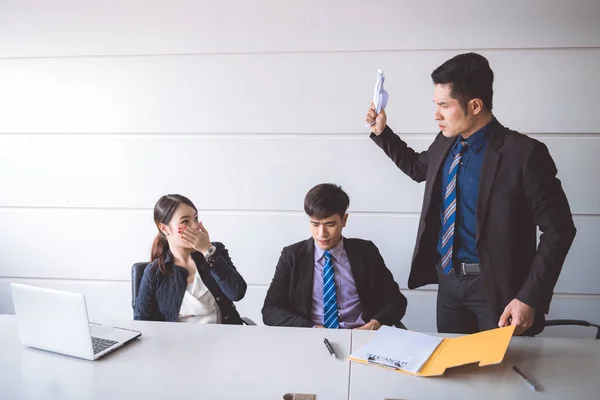 Businessman ripping off contract document. Young asian male in suit with beautiful young asia woman sitting together and saw man ripping off their contract document. Employment termination concept.