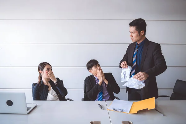 Businessman ripping off contract document. Young asian male in suit with beautiful young asia woman sitting together and saw man ripping off their contract document. Employment termination concept.