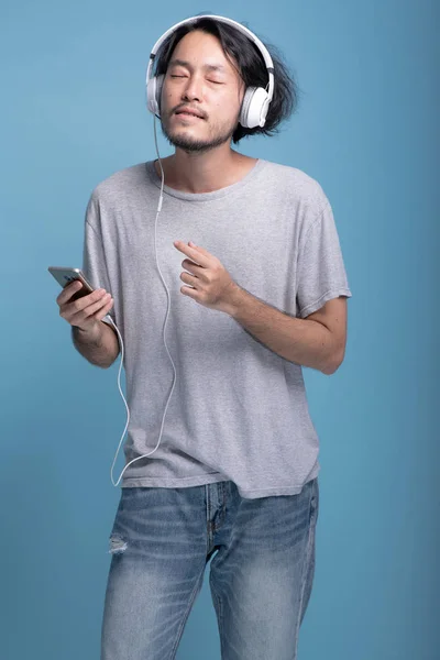 Young Bearded Man Listening Music Blue Background Very Relax Asian — Stock Photo, Image