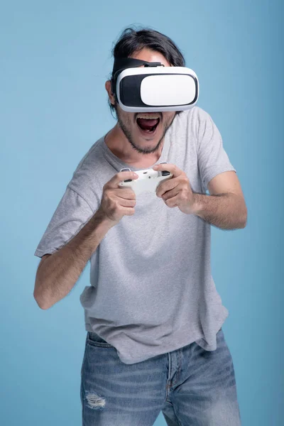 Young Bearded Man Playing Game Blue Background Very Excited Asian — Stock Photo, Image