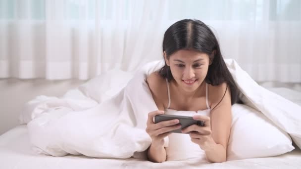 Donna Che Gioca Gioco Mobile Letto Asiatico Donna Utilizzando Cellulare — Video Stock