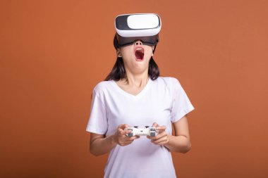 Kadın giyiyor Vr kulaklık. Poz şok edici beyaz t-shirt ile Vr kafa dişli, Genç Asyalı kadın. Yeni eğlence kavramının.