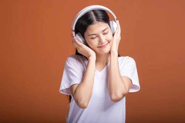 Женщина Использующая Наушники Изолированы Оранжевом Фоне Молодая Азиатка Слушает Музыку — стоковое фото