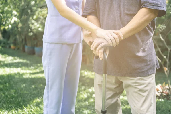 Comforting Hand Young Nurse Holding Old Man Hand Outdoor Garden — Stock Photo, Image