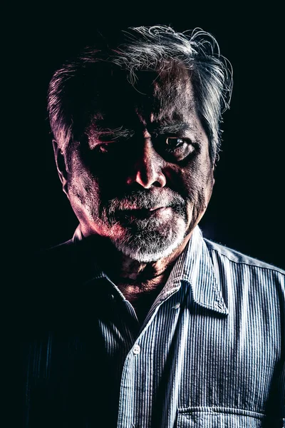 Rugged old man portrait. Old asian man with white beard. Dramatic lighting.